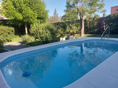 a swimming pool with blue water in a yard at No tiene nombre in Mina Clavero