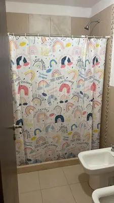 a bathroom with a shower curtain and a toilet at Beautiful y sofisticado apartment in Cordoba