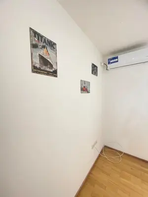 a room with a white wall with posters on it at Beautiful y sofisticado apartment in Cordoba