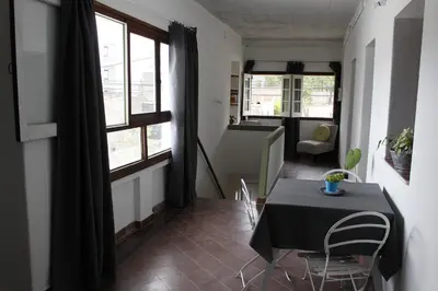 a dining room with a table and chairs in a room at Catalina House in Alta Gracia