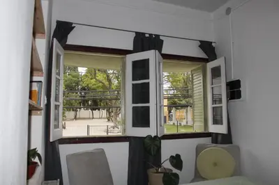 a room with a window with black curtains at Catalina House in Alta Gracia