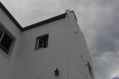 a white building with a window on the side of it at Catalina House in Alta Gracia