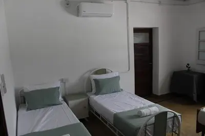 a hospital room with two beds and a window at Catalina House in Alta Gracia