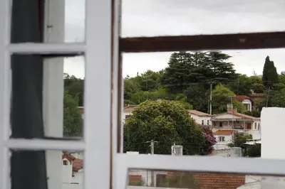 an open window with a view of a city at Catalina House in Alta Gracia