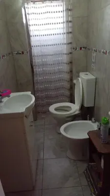 a bathroom with a toilet and a sink and a shower at La casita in Villa Santa Cruz del Lago