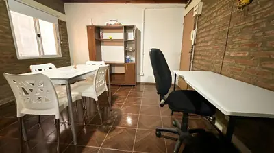 a dining room with a white table and chairs at Loft estilo rustico Alta Cba Wifi 100Mb y Escritorio in Cordoba