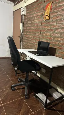 a desk with a laptop computer on top of it at Loft estilo rustico Alta Cba Wifi 100Mb y Escritorio in Cordoba