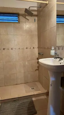 a bathroom with a sink and a shower at Loft estilo rustico Alta Cba Wifi 100Mb y Escritorio in Cordoba