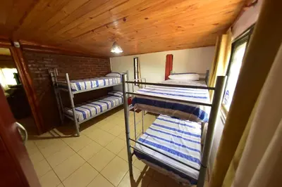 a room with three bunk beds with blue and white towels at Bialet Masse in Cuesta Blanca
