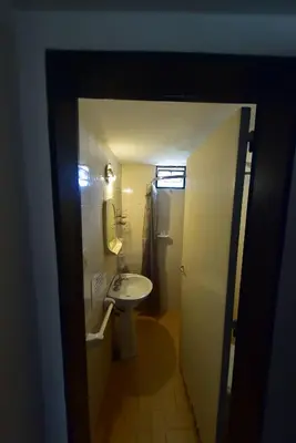 a small bathroom with a sink and a mirror at Bialet Masse in Cuesta Blanca