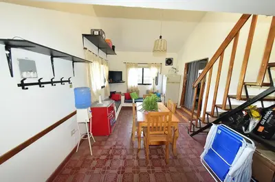 a kitchen and living room with a table and chairs at Bialet Masse in Cuesta Blanca