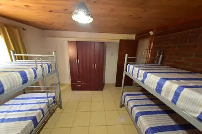 two bunk beds in a room with a door at Bialet Masse in Cuesta Blanca