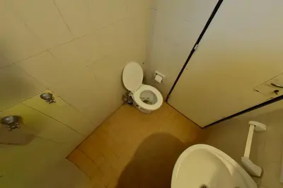 a small bathroom with a toilet and a sink at Bialet Masse in Cuesta Blanca