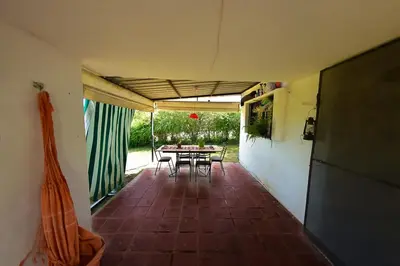 a patio with a table and chairs in a house at Bialet Masse in Cuesta Blanca