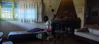 a living room with a couch and a table at La casa de los titiriteros in Mina Clavero