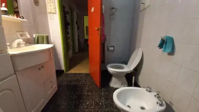 a small bathroom with a toilet and a sink at La casa de los titiriteros in Mina Clavero