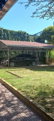 a car parked under a pavilion with a car parked under it at La casa de los titiriteros in Mina Clavero