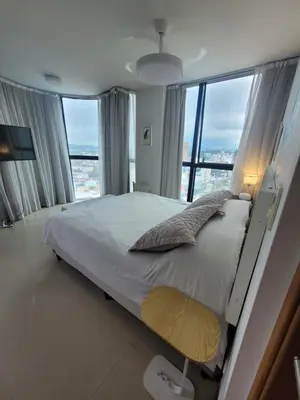 a bedroom with a large bed and a large window at Apartamento Ejecutivo Premium Riviera Tower in Villa Carlos Paz