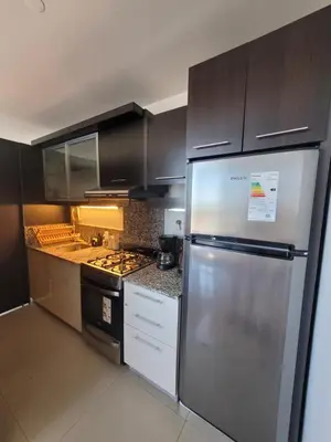 a kitchen with a stainless steel refrigerator and cabinets at Apartamento Ejecutivo Premium Riviera Tower in Villa Carlos Paz