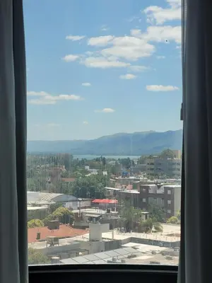 a view of a city from a window at Apartamento Ejecutivo Premium Riviera Tower in Villa Carlos Paz