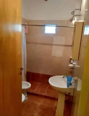 a bathroom with a sink and a toilet at Cosquin in Santa María