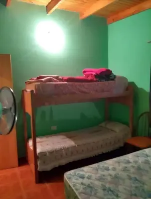 two bunk beds in a room with a green wall at Cosquin in Santa María