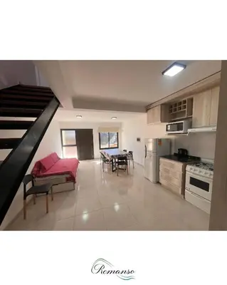 a kitchen and living room with a couch and a table at Remanso in Alta Gracia