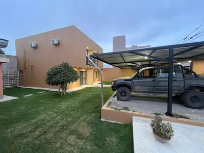 a jeep parked under a cover outside a house at Remanso in Alta Gracia