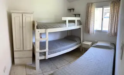 two bunk beds in a room with a window at Casa Temporal Bialet Massé in Bialet Massé