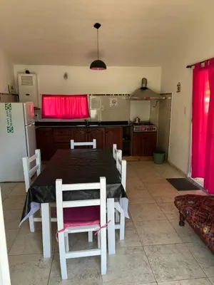 a kitchen with a table and chairs and a refrigerator at Casa Temporal Bialet Massé in Bialet Massé