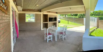a patio with a table and chairs on a house at Casa Temporal Bialet Massé in Bialet Massé