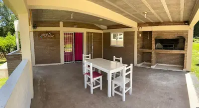 a patio with a white table and two chairs at Casa Temporal Bialet Massé in Bialet Massé
