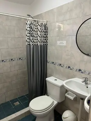 a bathroom with a toilet and a sink at Casa Temporal Bialet Massé in Bialet Massé