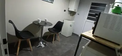 a room with a table and two chairs and a computer monitor at Premium Berrotarán in Berrotarán