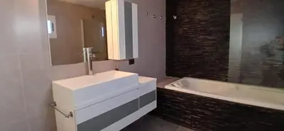 a bathroom with a white sink and a bath tub at Premium Berrotarán in Berrotarán