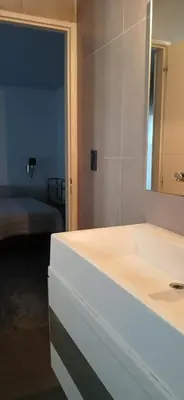 a bathroom with a sink and a mirror and a bed at Premium Berrotarán in Berrotarán