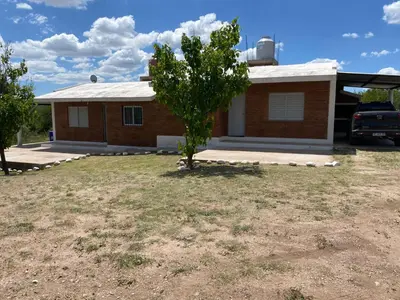 a house with a tree in front of it at Lucero de Brochero in Villa Cura Brochero