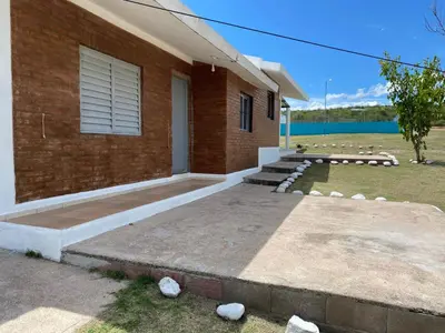 a brick house with a staircase outside of it at Lucero de Brochero in Villa Cura Brochero