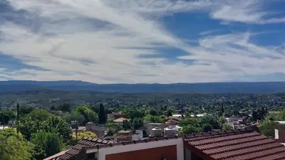 a view of a city with mountains in the distance at Duplex al pie de las sierras in Villa Carlos Paz