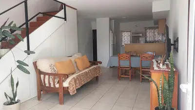 a living room with a couch and a table at Duplex al pie de las sierras in Villa Carlos Paz