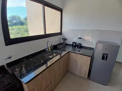 a kitchen with a sink and a refrigerator at Balcon del rio in Cavalango