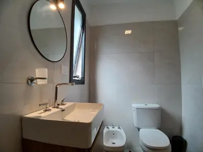 a bathroom with a sink and a toilet and a mirror at Balcon del rio in Cavalango