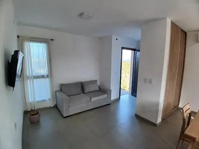 a living room with a couch and a television at Balcon del rio in Cavalango