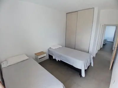 a room with two beds and a door to a bedroom at Balcon del rio in Cavalango