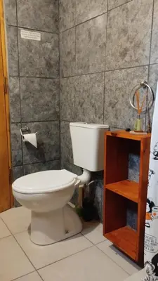 a bathroom with a white toilet in a room at Alpinanas in Arroyo de Los Patos