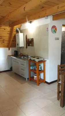 a kitchen with a counter and a table in a room at Alpinanas in Arroyo de Los Patos