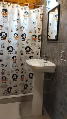 a bathroom with a sink and a shower curtain at Alpinanas in Arroyo de Los Patos