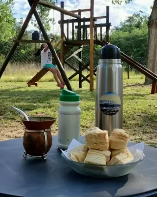 a table with a plate of bread and a thermos at Alpinanas in Arroyo de Los Patos