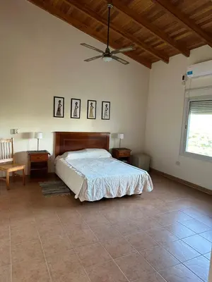 a bedroom with a bed and a ceiling fan at Casa Siquiman in Villa Parque Siquiman