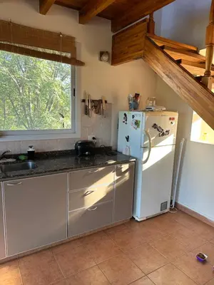 a kitchen with a white refrigerator and a window at Casa Siquiman in Villa Parque Siquiman